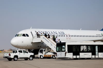 Passengers board a Syrian Air aircraft at Damascus International Airport in June. Reuters