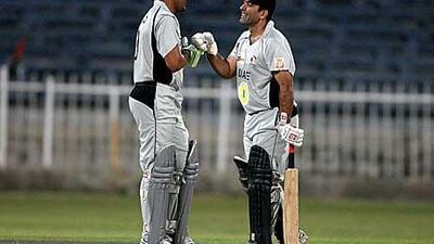 Hashmi, left, and Tauqir share notes during their 178-run stand.