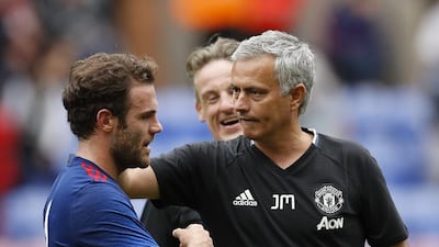 Juan Mata, left, with Manchester United manager Jose Mourinho. Lee Smith / Reuters