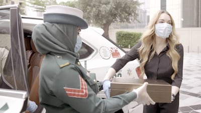 Lindsay Lohan safely covered up with gloves and a mask when she met members of Dubai Police. Instagram / Lindsay Lohan