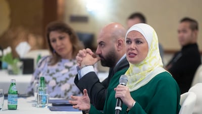An attendee asking questions at the event in Dubai.