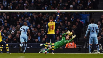 Santi Cazorla, left, scores the opening goal from the penalty spot past a diving Manchester City’s English goalkeeper Joe Hart. Paul Ellis/AFP