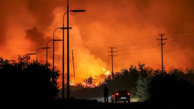 A wildfire burns in central Greece last month. Climate change is a huge threat but also presents a tremendous opportunity for investors across a range of sectors. Reuters