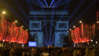 Revellers gather near the Arc de Triomphe at the Champs-Elysees for New Year's celebrations in the French capital Paris on December 31, 2018. AFP
