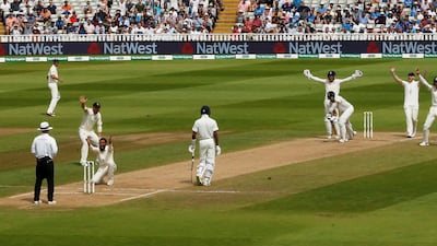 England leg-spinner Adil Rashid celebrates the wicket of India's Ishant Sharma with teammates. Reuters