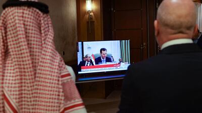 Media delegates watch on a screen Syrian President Bashar Al Assad addressing the Arab League summit in Jeddah this month. AFP