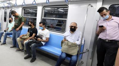 Egyptians wearing protective face masks at the underground Al Shohadaa metro station in Cairo. EPA