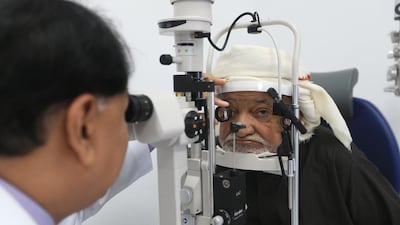 Dr Najmi Rahman checks a patient’s eyes during a screening at the new Oud Al Touba Healthcare Centre in Al Ain. Ravindranath K / The National