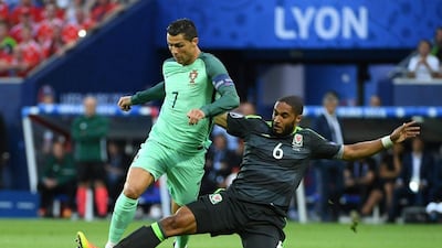 Ashley Williams (R) of Wales fouls Cristiano Ronaldo of Portugal during the Uefa Euro 2016 semi-final match between Portugal and Wales at Stade de Lyon in Lyon, France, 06 July 2016. Filip Singer / EPA