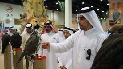 Visitors check the prices of falcons on the second day of the Abu Dhabi International Hunting and Equestrian Exhibition yesterday at Adnec.
