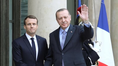 In this file photo taken on January 5, 2018 French President Emmanuel Macron (L) greets his Turkish counterpart Recep Tayyip Erdogan upon his arrival at the Elysee palace in Paris. AFP