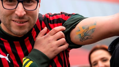 A supporter shows a tattoo with the Swedish flag and a signature of Zlatan Ibrahimovic. AFP