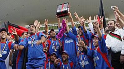 Afghanistan celebrate winning the ACC Twenty20 Trophy at the Zayed Cricket Stadium yesterday.