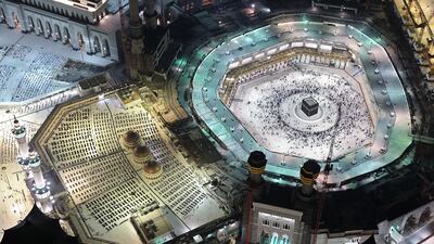 An aerial view of the Makkah Royal Clock Tower in the Abraj Al Bait skyscraper complex. Worshippers can be seen praying around the Kaaba, the holiest shrine in the Grand Mosque complex in Makkah, Saudi Arabia. AFP