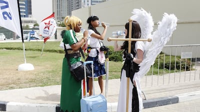 Three ‘characters’ cool off outside the Middle East Film and Comic Con in Dubai last April. Sarah Dea / The National