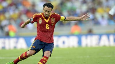 Spain's midfielder Xavi Hernandez drives the ball during a Fifa Confederations Cup Brazil 2013 match against Nigeria, at the Castelao Stadium in Fortaleza on June 23, 2013. Xavi Hernandez announced on August 5, 2014 his retirement from the Spanish team. AFP PHOTO / LLUIS GENE