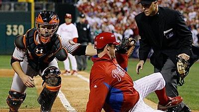 Philadelphia Phillies’ Roy Oswalt slides safely home past Buster Posey, the San Francisco Giants catcher, during the seventh inning of Game 2 of the NL Championship Series on Sunday.