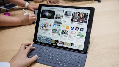 An attendee demonstrates the keyboard with the Apple iPad Pro tablet. David Paul Morris / Bloomberg