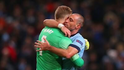Pablo Zabaleta of Manchester City hugs Joe Hart of Manchester City after he saved a penalty from Lionel Messi of Barcelona during the first leg of their Champions League last 16 tie on Tuesday. Alex Livesey / Getty Images