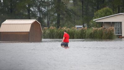 A man walks through a flooded field to his home during Tropical Storm Florence in Lumberton, North Carolina. Reuters