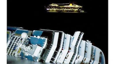 The cruise ship Costa Serena passes offshore as its sister ship Costa Concordia lies on its side off the Tuscan island of Giglio. The Italian Ambassador says that a cartoon depiction of the accident was in poor taste. Angela Carconi / AP