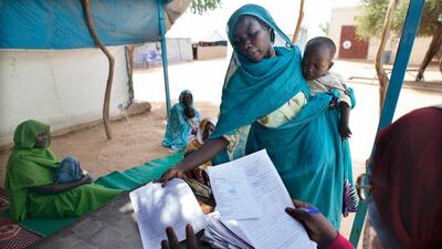Critics of blanket subsidies say they benefit the wealthy more than the poor – like this mother of a malnourished child in Darfur – diverting public funds from health, education and welfare. Albert Gonzales / EPA