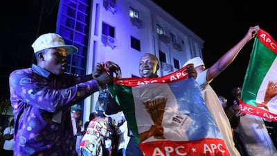 Supporters of the ruling All Progressives Congress (APC) celebrate with party flags in Abuja, Nigeria. AFP
