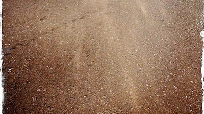 Day trip with friends to the Western Region and the Mazayin Dhafra Camel Festival, 220 kms west of Abu Dhabi on December 20, 2013. Sand blew across the pavement during a sandstorm. Picture taken with the Hipstamatic app for the iPhone. Liz Claus / The National