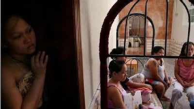 Merly Perez, centre, along with her co-workers of Lavito Building Cleaning Services, sit in their company villa in Ajman on Sunday after their employers abandoned them, owing months of pay. Amy Leang / The National