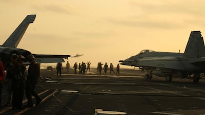 US Navy sailors launch an F/A-18 Super Hornet from the flight deck of the aircraft carrier USS Abraham Lincoln, in Arabian Sea. Reuters