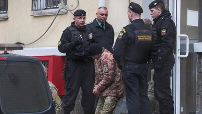 A detained Ukrainian sailor is escorted to a car after a court hearing in Simferopol, Crimea. AFP