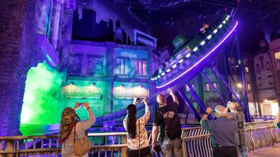 Guests inspect the Riddler Revolution ride. Antonie Robertson / The National