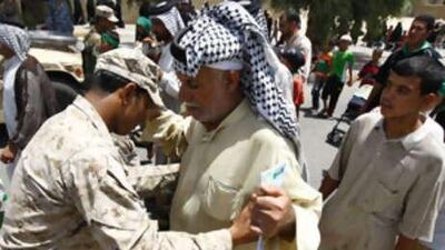 An Iraqi soldier searches a Shiite pilgrim heading to the Imam Moussa al Kadhim shrine yesterday. At least 1 million people are expected to take part today in the pilgrimage in the Iraqi capital.
