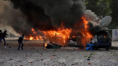 Broadcast vans of television channels go up in flames during protests against India's new citizenship law in Lucknow, India, Thursday, Dec. 19, 2019. Police detained several hundred protesters in some of India's biggest cities Thursday as they defied bans on assembly that authorities imposed to stop widespread demonstrations against a new citizenship law that opponents say threatens the country's secular democracy. (AP Photo)