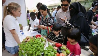 Families shop for organic vegetables at the Ripe stall at The Market@Masdar City yesterday.