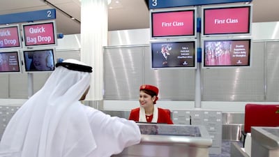Dubai International Airport has hired extra staff for the Eid holiday rush. Above, an Emirates Airline ground staff checks in a guest. Ali Haider / EPA