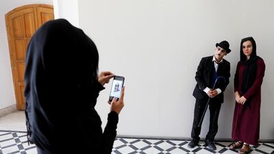 A woman takes a picture of Karim Asir in Kabul. Reuters