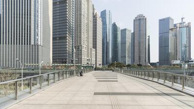 Skyscraper buildings stand beyond an empty pedestrian bridge that connects office buildings in the Lujiazui Financial District in Shanghai, China. The death toll from the coronavirus outbreak has now climbed above 1,770. Bloomberg