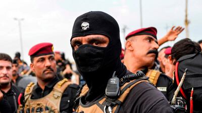 Members of the Iraqi security forces confront protesters during a demonstration against corruption and lack of basic services in the city of Najaf. AFP