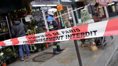 A police officer stands behind a cordon. EPA