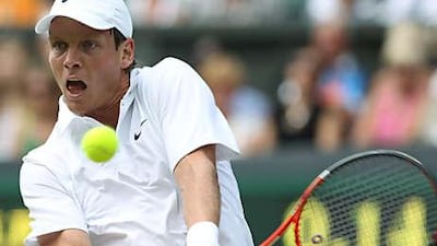 Tomas Berdych fires back a return during his victory over Roger Federer at Wimbledon yesterday.