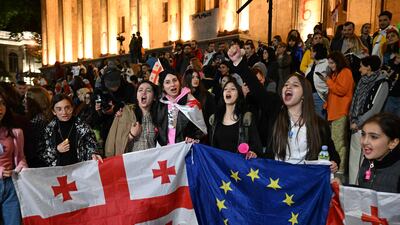 Protesters chant as they demonstrate against the 'foreign influence' law, outside the Georgian Parliament in Tbilisi, on Saturday. AFP