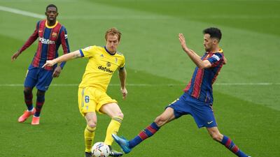 Barcelona midfielder Sergio Busquets challenges Cadiz goalscorer Alex Fernandez. AFP