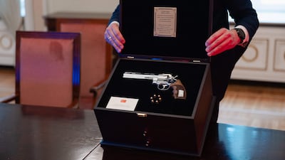 This handout photo taken and obtained on July 9, 2026 from the office of the Lithuanian President shows a revolver offered by Turkish President Recep Tayyip Erdogan to Lithuanian President Gitanas Nauseda with the president's name engraved, including live rounds, and displayed during a press presentation in Vilnius, Lithuania. What does a world leader do with a gun and six bullets? That was the conundrum NATO leaders faced after the Turkish president offered them each a revolver after the Ankara summit. AFP