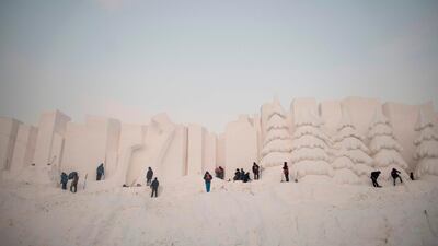 Workers carve their snow sculptures. AFP