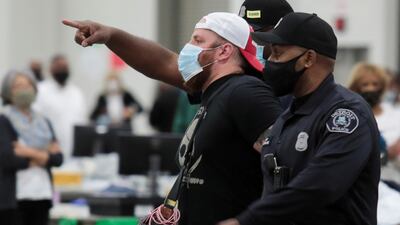 Detroit police escort a poll challenger out after he refused to leave, due to room capacity, at the TCF Center after Election Day in Detroit, Michigan. Reuters