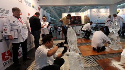 Participants get busy during the ice-carving competition at Gulfood. Satish Kumar / The National