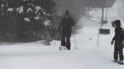 A woman gets by on cross-country skis in Wrentham, Massachusetts. Matt Campbell / EPA