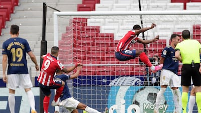 Luis Suarez, left, scores Atletico Madrid's second goal against Osasuna. AP