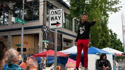 An organiser rallies protesters in the Capitol Hill Organised Protest area on Monday in Seattle. Getty Images/AFP